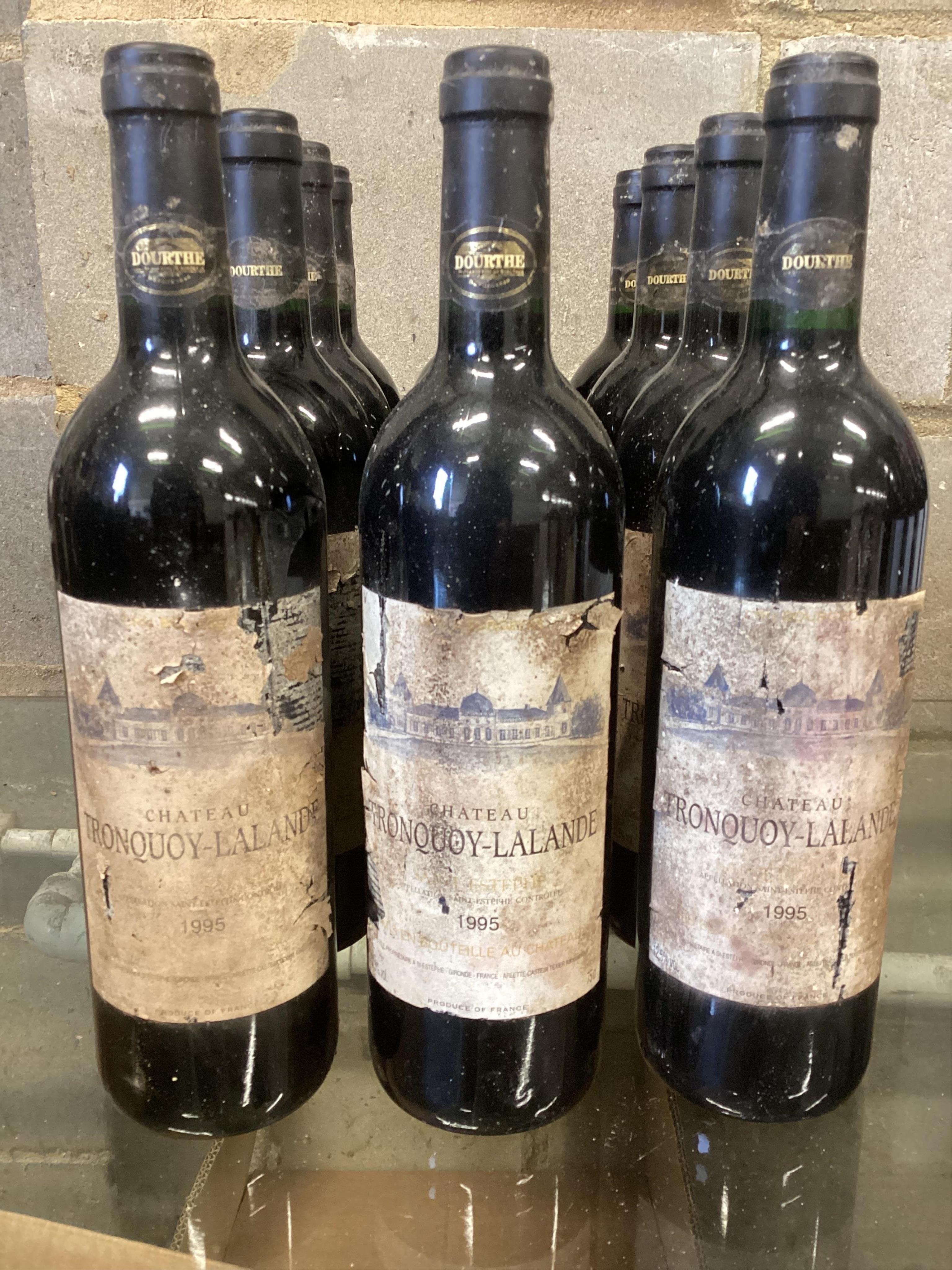 Twelve bottles of Chateau Tronquoy Lalande St Estephe 1995. (From a local private cellar). Condition - labels degraded